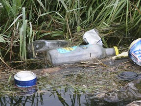 Discarded beer and alcohol bottles are shown in a ditch in front of The South Point Stables property at 9076 County Rd. 42 on Monday, June 15, 2015, where a massive prom party was held on Friday where three people were stabbed.  (DAN JANISSE/The Windsor Star)