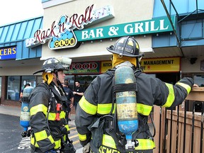 Windsor firefighters are shown at the scene of a fire at the Rack n' Roll restaurant in Forest Glade on Monday, June 8, 2015. (DAN JANISSE/The Windsor Star)