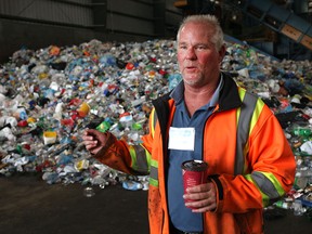 Cam Wright, waste division manager at Essex-Windsor Solid Waste Authority, is pictured in front of a day's worth of collected plastics from Windsor and the county during an open house at the recycling centre, Sunday, June 14, 2015.  (DAX MELMER/The Windsor Star)