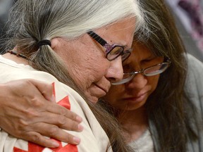 A woman is comforted in the audience during the closing ceremony of the Indian Residential Schools Truth and Reconciliation Commission, at Rideau Hall in Ottawa on Wednesday, June 3, 2015. (Sean Kilpatrick/The Canadian Press)