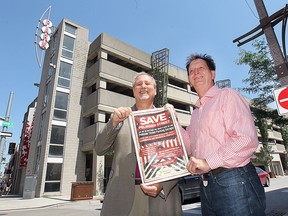 The Downtown Windsor Business Improvement Association held a media conference on Wednesday, June 10, 2015, to express concerns about the loss of any ground level commercial units at the Pelissier Street Parking Garage.  DWBIA president Larry Horwitz (L) and Windsor city councillor Paul Borelli pose with a poster designed to help save the commercial units. (DAN JANISSE/The Windsor Star)