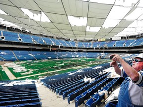 In this May 12, 2014 file photo,   Ron "Crackman" Crachiola takes a picture on his cell phone at the Pontiac Silverdome in Pontiac,  Mich.  The Pontiac Silverdome is up for sale again, with an asking price of about $30 million. The former home of the Detroit Lions was sold for 583,000 six years ago. Real estate broker Robert Mihelich says the stadium and its property went back on the market recently and has already recived offers. (Daniel Mears/Detroit News via AP)