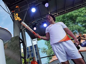 Boxer Mary Spencer lights the cauldron as the Pan Am Games torch makes it's way into Windsor on Tuesday, June 16, 2015.                (TYLER BROWNBRIDGE/The Windsor Star)