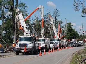 Hydro One crews replace utility poles along Seacliff Drive in Leamington, Ont. during efforts to restore power to the southwestern Ontario town. (JASON KRYK/The Windsor Star)