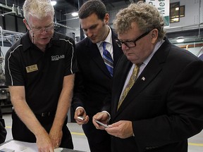 Files: Robert Chittim,  left, MP Jeff Watson and Ed Holder, Minister of State,  take part in a tour of the Ford Centre for Excellence in Manufacturing at St. Clair College in Windsor on June 30, 2014.        (Tyler Brownbridge/The Windsor Star)