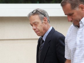 Thomas Chauvin, left, walks out of the Ontario Court of Justice with an unidentified man after being found guilty of voyeurism, Friday, June 5, 2015.  (DAX MELMER/The Windsor Star)