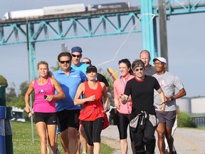 Ontario Premier Kathleen Wynne, front and centre in red, took an early morning run with a small group of Windsor runners June 19, 2015. (DAN JANISSE/The Windsor Star)