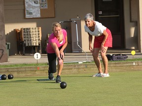 The Star’s Kelly Steele rolls her bowl under the watchful eye of Windsor Lawn Bowling Club president Kathryn MacGregor. (JASON KRYK / The Windsor Star)