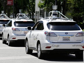 This May 13, 2014 file photo shows a row of Google self-driving Lexus cars at a Google event in Mountain View, Calif. Jaguar Land Rover will never make a driverless car, according to a recent report from Automotive News. (Eric Risberg / Associated Press files)