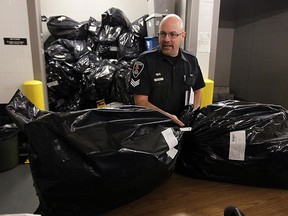 In this photo from Nov. 21, 2012, Windsor police Sgt. Matthew D'Asti displays 491 pounds of marijuana seized in Amherstburg the previous week. (TYLER BROWNBRIDGE / Windsor Star files)
