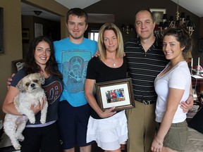The Altenhof family,  Stephanie, left, holding the family pet Charlie,  Adam, Kirsten, Mike and Sarah at their LaSalle home on June 2, 2015.  (JASON KRYK/The Windsor Star)