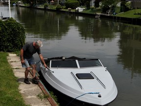 Gary Bourque can't do anything with his 22-foot pleasure boat which is tied up on Little River Friday July 03, 2015.  Because of high water levels, Bourque wouldn't be able to fit under the bridge over Little River at Riverside Drive East.  (NICK BRANCACCIO/The Windsor Star).