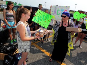 Emma Gregoire, left, delivers food to Linda Santos of Transition to Betterness on Malden Road on Saturday July 04, 2015. Gregoire, who turned 14 on June 19, wanted to give back to the community rather than celebrate with a traditional birthday party. Santos accepted the generous donation which are destined for patients at the Tayfour Campus of Windsor Regional Hospital. (NICK BRANCACCIO/The Windsor Star).