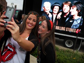 Kayla Windram, left, and Ashley Edwards, both of Windsor pause for a selfie outside Comerica Park where Rolling Stones performed Wednesday July 8,2015. (NICK BRANCACCIO/The Windsor Star)