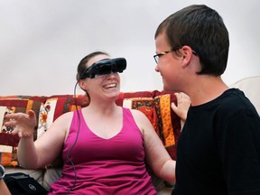 Jen Bauder, who is legally blind, had a chance to see her two sons clearly on Thursday, July 2, 2015, thanks to the generous donation of an anonymous individual. She was able to purchase eSight glasses after an online campaign raised the $15,000 cost. Bauder reacts with a huge smile after seeing her son P.J. Totten, 12, with the high-tech glasses. (DAN JANISSE/The Windsor Star)