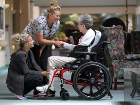 Chartwell Leamington Retirement Residence personal support workers Melanie Groleau and Melissa Branch spend time with long-term care resident Shirley Fobe in Leamington, Ont., on July 13, 2015. (JASON KRYK/The Windsor Star)