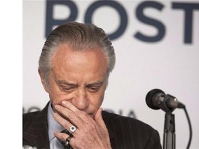 Postmedia President and Chief Executive Officer Paul Godfrey prepares to speak at a press conference in Toronto Monday, Oct. 6, 2014. Postmedia's latest results showed it still has a lengthy battle ahead in its plan to return to profitability. (THE CANADIAN PRESS/Hannah Yoon)