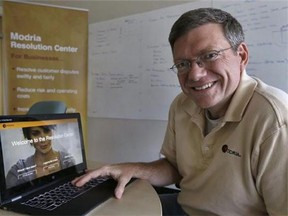 In this July 2, 2015 photo, Colin Rule, CEO of Modria, poses with the Modria resolution software operating on his laptop at his company's headquarters in San Jose, Calif. Experts say Modria is at the forefront of the next wave of legal technology in which laws are translated into computer code that can solve potential legal battles without the need for a judge or attorney. (AP Photo/Ben Margot)
