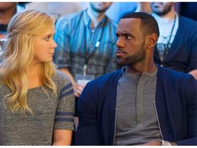 This image released by Universal Pictures shows Amy Schumer, left, and LeBron James, in a scene from the comedy, "Trainwreck." (Mary Cybulski/Universal Pictures via AP)