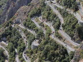 Riders, team cars and press motorcycles climb the harpins of Montvernier during the eighteenth stage of the Tour de France cycling race over 186.5 kilometers (115.9 miles) with start in Gap and finish in Saint-Jean-de-Maurienne, France, Thursday, July 23, 2015. (AP Photo/Laurent Cipriani)