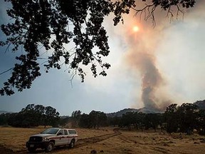 A column of smoke rises from the Wragg fire near Winters, Calif., on Thursday, July 23, 2015. According to Cal Fire, the blaze scorched more than 6,000 acres and is threatening 200 structures. (AP Photo/Noah Berger)