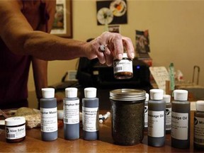 A variety of the cannabis oil available to customers is shown at the Cannabis Buyers Club, in Victoria, B.C., on June 11, 2015. Canadians who have been prescribed medical marijuana could one day see their insurance company footing the bill, experts predict, following the introduction of new Health Canada rules that allow for the sale of cannabis oils. THE CANADIAN PRESS/Chad Hipolito