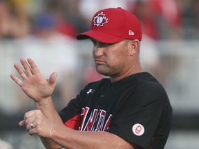 Third base coach Stubby Clapp of Windsor delivers a sign during the Pan Am Games in Ajax Ont, on Monday July 13, 2015. Canada vs Nicaragua in the preliminary round. (Veronica Henri/Toronto Sun/Postmedia Network)