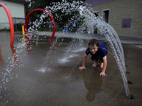 Nathan Miller, 8, had no problem trying each station of AKO Community Centre splash pad on a warn afternoon Friday July 17,2015. A high heat advisory has been issued for our area starting Saturday. (NICK BRANCACCIO/The Windsor Star)