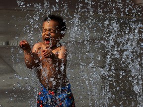 Jaxon White-Mailloux, 2, visits AKO Community Centre splash pad for the first time on a warn afternoon Friday July 17,2015. A high heat advisory has been issued for our area starting Saturday. (NICK BRANCACCIO/The Windsor Star)