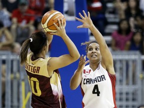Windsor's Miah Marie Langlois, right, defends against Venezuela's Luisana Ortega Ochoa (10) in the first half of a women's preliminary round basketball game at the Pan Am Games Thursday, July 16, 2015, in Toronto. Canada won 101-38. (AP Photo/Mark Humphrey)