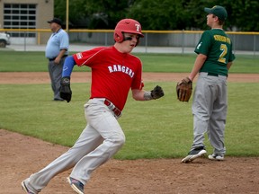 Curtis Zimmerman, centre, of Tecumseh Rangers Bantam Majors heads to third base and scores on a base hit as LaSalle Titans Mitch With, right, waits for a throw from his teammate at Town Hall Park Thursday July 16, 2015. Umpire Steve Dupuis, left, watches the play. (NICK BRANCACCIO/The Windsor Star)