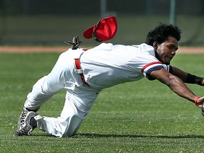 Erindale's Aaron Palmer just misses making a catch against WAA during the provincial senior elimination tournament at Cullen Field in Windsor on Friday, July 31, 2015.                          (TYLER BROWNBRIDGE/The Windsor Star)