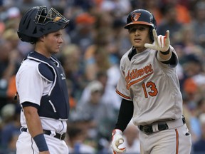 Manny Machado #13 of the Baltimore Orioles celebrates his solo home run as he crosses home plate in front of catcher James McCann #34 of the Detroit Tigers during the third inning at Comerica Park on July 18, 2015 in Detroit, Michigan. The Orioles defeated the Tigers 3-0. (Photo by Duane Burleson/Getty Images)