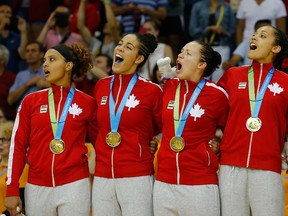 Windsor's Miah-Marie Langlois, left, and her Team Canada teammates celebrate their Gold Medal win against the USA after the Women's Baskeball Finals at the Pan Am Games on July 20, 2015 in Toronto, Canada.  (Photo by Al Bello/Getty Images)