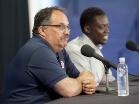 Pistons head coach Stan Van Gundy, left, and guard Reggie Jackson talk during a news conference Monday, July 20, 2015, in Auburn Hills, Mich. Pistons have taken care of one priority for this offseason — bringing restricted free agent Jackson back as the team's point guard. (David Guralnick /Detroit News via AP)
