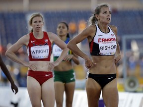 Former Lancer Melissa Bishop, right, looks up after competing in the semifinals of the women's 800 meter run during the Pan Am Games in Toronto, Tuesday, July 21, 2015. Behind her are USA's Phoebe Wright and Brazil's Erika Lima. (AP Photo/Mark Humphrey)