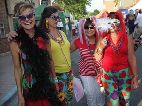 Dressed for the event, Doreen Beaudoin, left, Diana Slyzuk, Marie McLean and Betty Peltier join the Mardi Gras Street Party in downtown Amherstburg, Friday July 24, 2015.  (NICK BRANCACCIO/The Windsor Star)