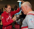 Melissa Bishop, left, gives University of Windsor track head coach Dennis Fairall, right, the gold medal Bishop won in the 800 metres at Pan American Games Thursday July 23, 2015.  Bishop arrived at Windsor Airport to a celebration with friends, teammates and coaches. (NICK BRANCACCIO/The Windsor Star)