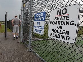 Daniel Tilahun, 21, left, and Vladimir Yousif, 20, both former students at St. Joseph's Catholic High School are annoyed the school's basketball court has been locked, Wednesday July 29, 2015. (NICK BRANCACCIO/The Windsor Star)