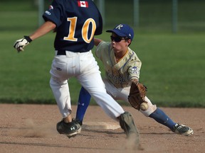 The Walker Homesites Andrew Bastable makes it safely to second after the throw from home skips off the glove of Riverside's Stefano Kerr at Walker Homesite Park in Windsor on Tuesday, July 28, 2015.                          (TYLER BROWNBRIDGE/The Windsor Star)