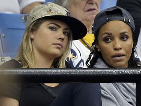 Model Kate Upton, left, watches Detroit Tigers' Justin Verlander pitch against the Tampa Bay Rays during the fifth inning of a baseball game Wednesday, July 29, 2015, in St. Petersburg, Fla.  (AP Photo/Chris O'Meara)