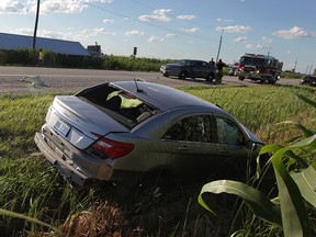 A two-vehicle collision on Manning Road near Baseline Road sent a tractor-trailer into the southbound ditch of Manning while a Chrysler 200 ended up in the northbound ditch beside a field of corn Friday July 31, 2015. Traffic was shut down for hours in both directions. (NICK BRANCACCIO/The Windsor Star)