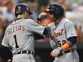 Detroit Tigers' Yoenois Cespedes, right, is congratulated by teammate Jose Iglesias after hitting a two-run home run against the Baltimore Orioles in the fourth inning of a baseball game, Thursday, July 30, 2015, in Baltimore. (AP Photo/Gail Burton)
