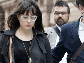Twitter complainant Stephanie Guthrie, left, leaves Toronto's Old City Hall court houses, Wednesday May 7, 2014. (Postmedia News files)