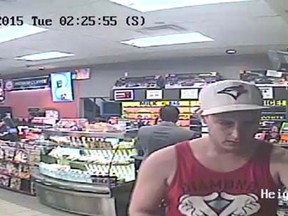 A suspect in a fraud investigation is pictured at a convenience store in this surveillance photo on June 23, 2015. (Courtesy of Windsor police)