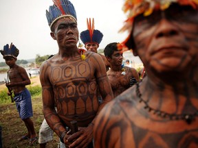 Members of the Munduruku indigenous tribe gather along the Tapajos River during a protest by indigenous groups and supporters who oppose plans to construct a hydroelectric dam on the river in the Amazon rainforest on November 27, 2014 (Mario Tama/Getty Images)