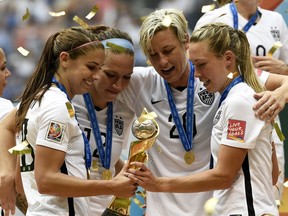 (L-R) USA's Alex Morgan, Lauren Holiday, Abby Wambach and Whitney Engen celebrate after winning the final 2015 FIFA Women's World Cup match between USA and Japan at the BC Place Stadium in Vancouver on July 5, 2015.  AFP PHOTO / FRANCK FIFEFRANCK FIFE/AFP/Getty Images