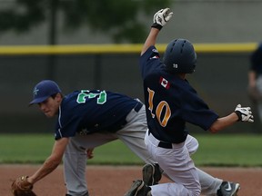 The Walker Homesites Andrew Bastable is caught stealing by the Windsor Stars Shane Laforest at Bernie Soulliere Field in Windsor on Wednesday, July 8, 2015.                         (TYLER BROWNBRIDGE/The Windsor Star)