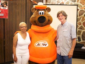 William Clinansmith, and his wife, Adrienne Clinansmith, left, celebrate their 40th wedding anniversary A&W style with Rooty, the A&W mascot, Saturday, July 18, 2015.  (Dane Wanniarachige/The Windsor Star)