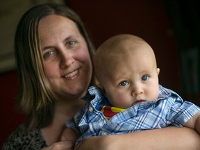 Jessie Hardcastle holds her son, Jackson Hardcastle, seven months, at her home in east Windsor, Sunday, July 12, 2015.  Jackson has low muscle tone in his neck and back which is causing his skull to have an irregular shape. (DAX MELMER/The Windsor Star)